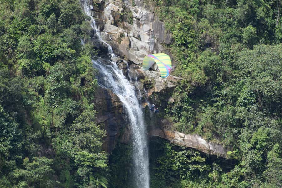 From Medellín: Paragliding and Rafting Combo Tour - Paragliding above mountains and waterfalls